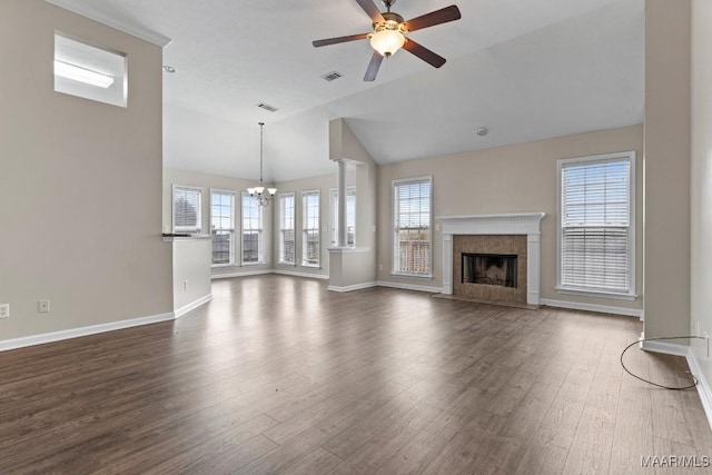 unfurnished living room with vaulted ceiling, a high end fireplace, dark hardwood / wood-style flooring, and ceiling fan with notable chandelier