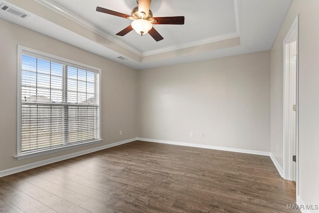 unfurnished room with dark wood-type flooring, ornamental molding, a raised ceiling, and ceiling fan