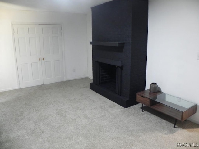 living room with light colored carpet and a fireplace