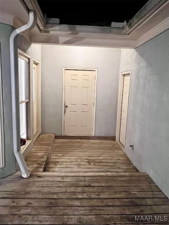 hallway with hardwood / wood-style floors