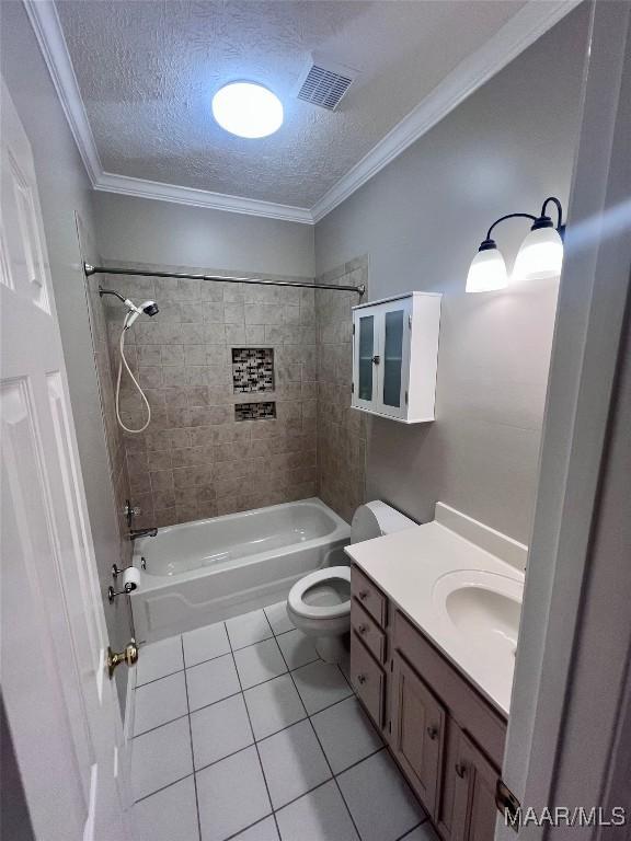 full bathroom with tiled shower / bath, a textured ceiling, ornamental molding, and toilet