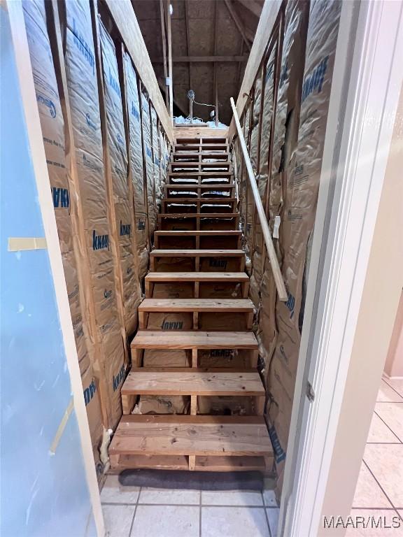 stairs featuring tile patterned floors