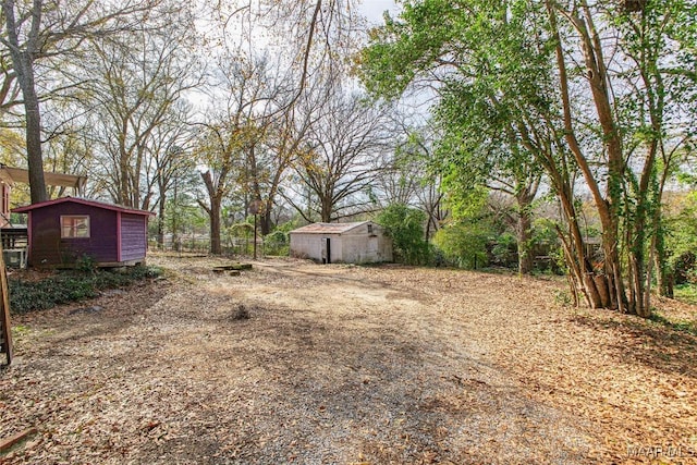 view of yard with an outbuilding and a storage shed