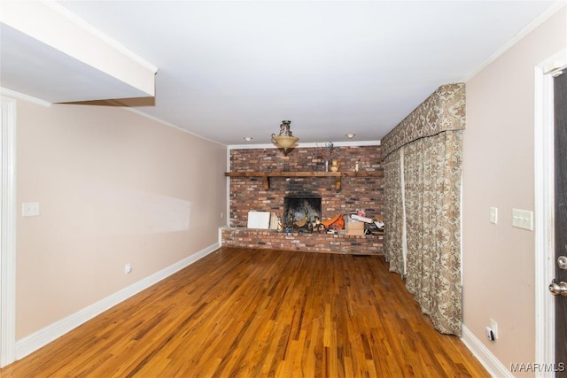 unfurnished living room featuring crown molding, hardwood / wood-style floors, and a fireplace