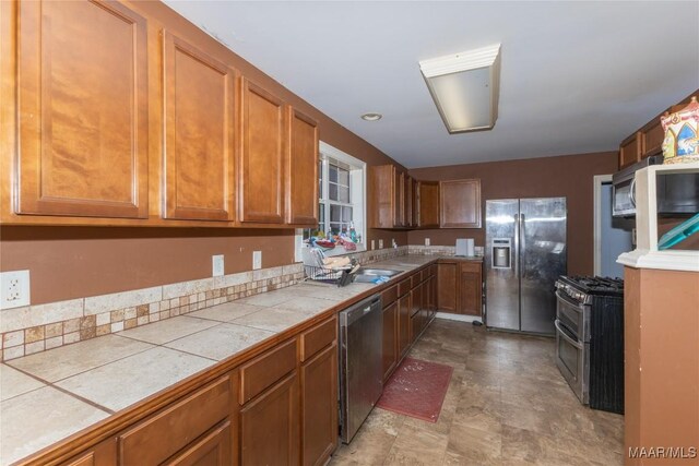 kitchen featuring stainless steel appliances and tile countertops