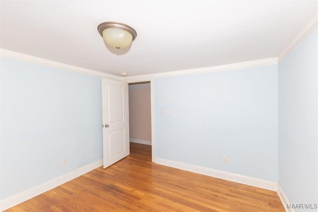 unfurnished room featuring hardwood / wood-style floors and ornamental molding