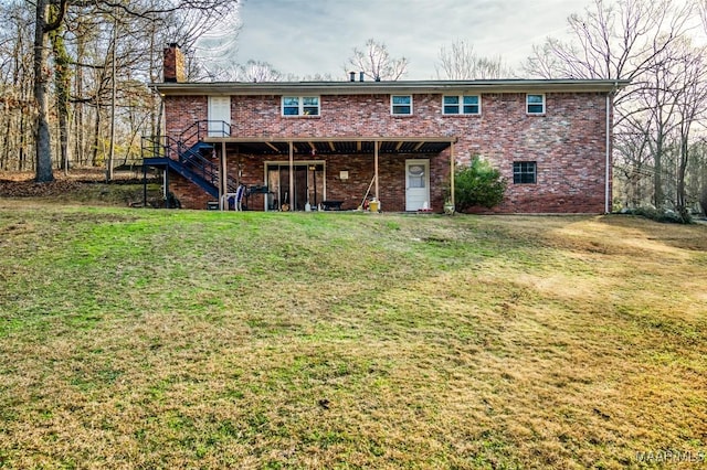 back of house with a deck and a lawn