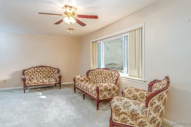 living area with ceiling fan and carpet flooring