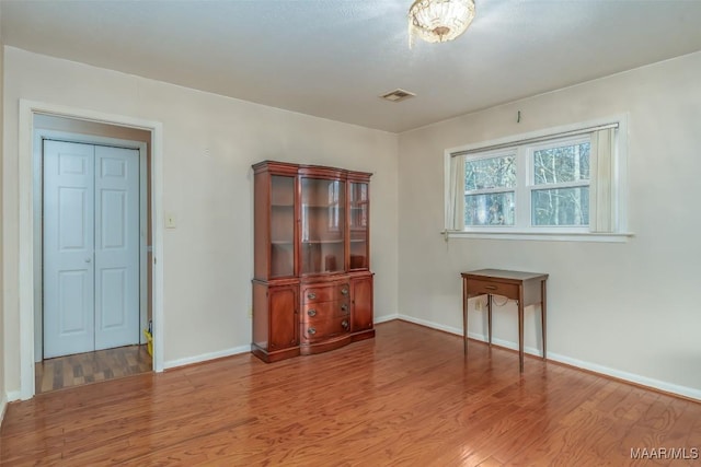 unfurnished room featuring hardwood / wood-style flooring