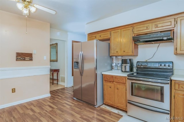 kitchen with stainless steel appliances, ceiling fan, and light wood-type flooring