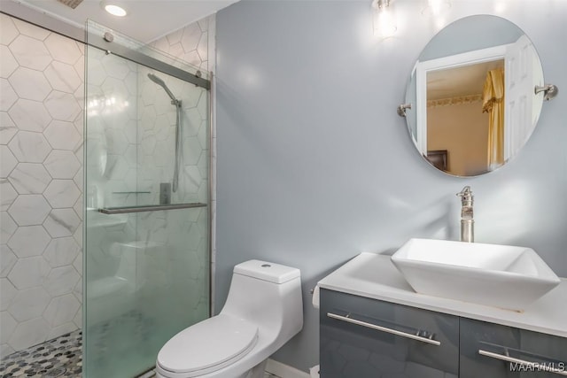 bathroom with a shower with door, vanity, and toilet