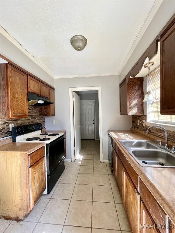 kitchen with crown molding, sink, light tile patterned flooring, and electric range