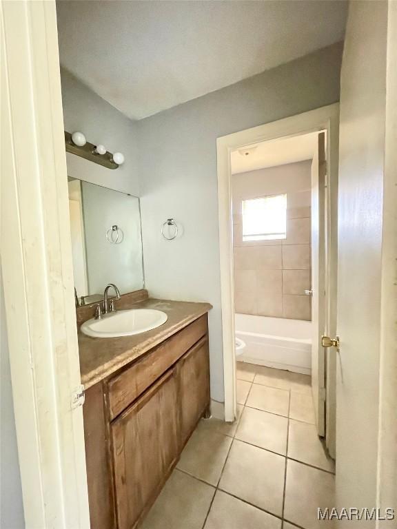 bathroom with vanity, tile patterned floors, and toilet