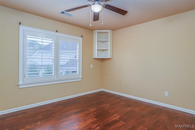 unfurnished room with dark wood-type flooring and ceiling fan