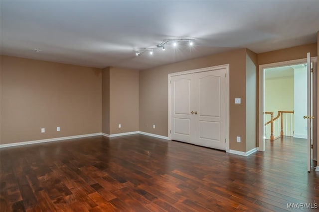 unfurnished bedroom with dark hardwood / wood-style flooring