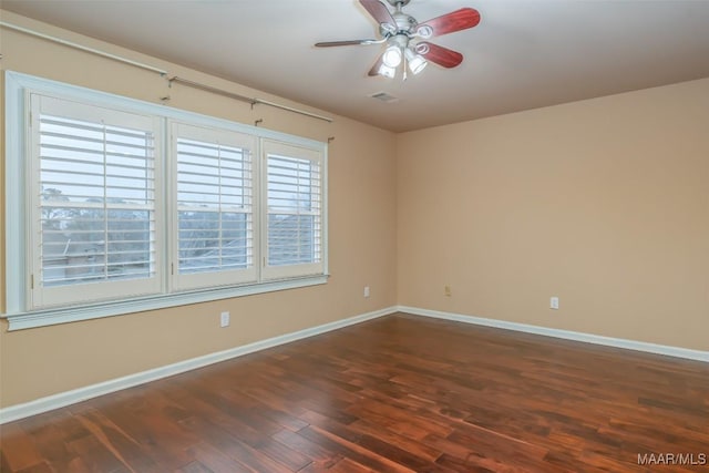 unfurnished room with ceiling fan and dark hardwood / wood-style flooring