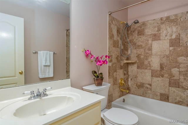 full bathroom with vanity, toilet, and tiled shower / bath