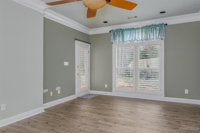 spare room featuring crown molding, wood-type flooring, and ceiling fan