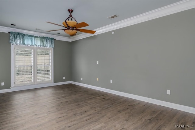 spare room with crown molding, ceiling fan, and wood-type flooring