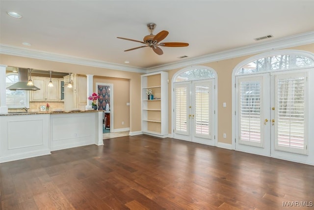 unfurnished living room featuring french doors, ornamental molding, and dark hardwood / wood-style floors