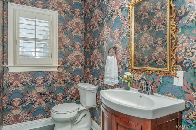 bathroom featuring vanity and toilet