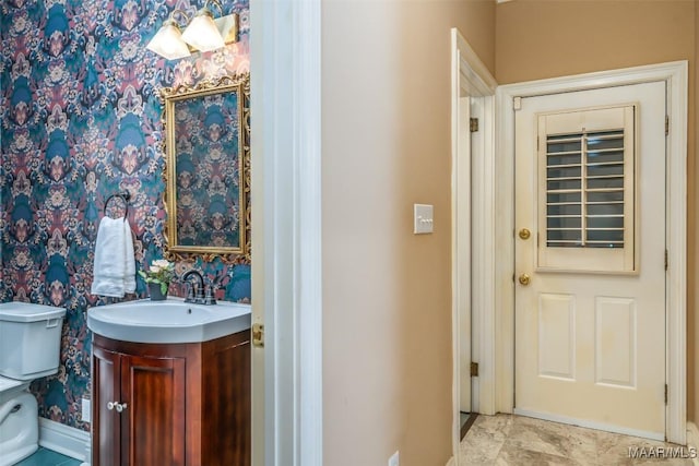 bathroom featuring vanity and toilet