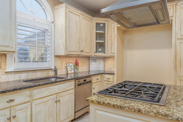 kitchen with sink, dark stone countertops, stainless steel appliances, custom range hood, and decorative backsplash