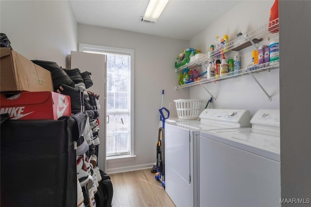 washroom featuring separate washer and dryer and light hardwood / wood-style floors