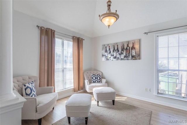 sitting room featuring vaulted ceiling and light hardwood / wood-style flooring