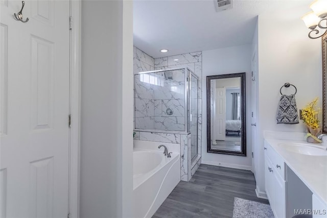 bathroom with vanity, separate shower and tub, and hardwood / wood-style floors