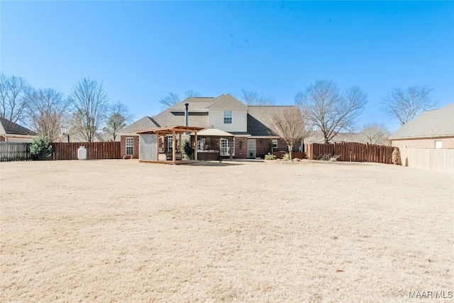 back of house with a fenced backyard