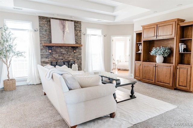 living area featuring a raised ceiling, light carpet, crown molding, and visible vents