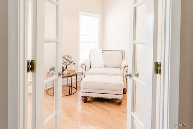 living area featuring baseboards and wood finished floors