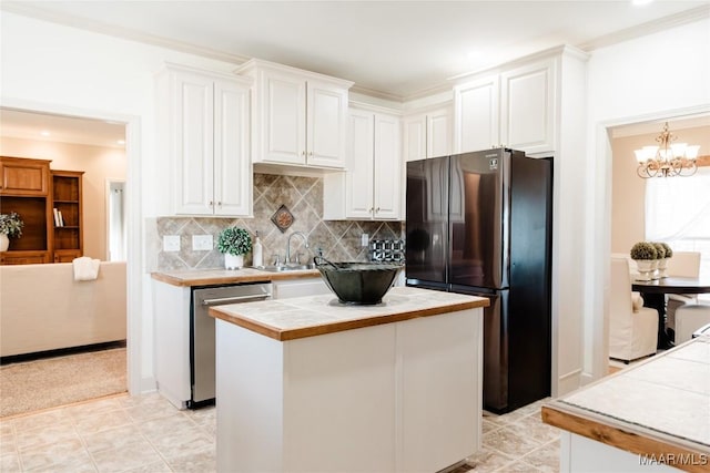 kitchen with tile counters, freestanding refrigerator, white cabinetry, and dishwasher