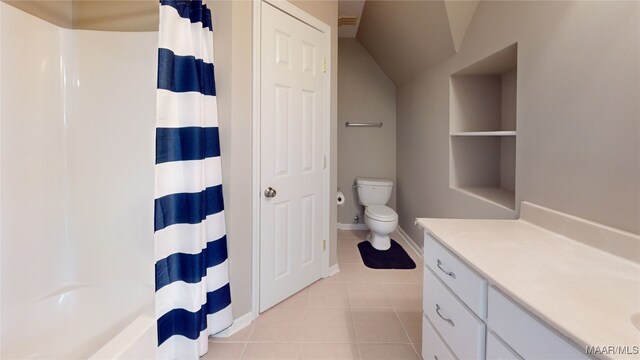 full bath with curtained shower, toilet, vaulted ceiling, vanity, and tile patterned floors