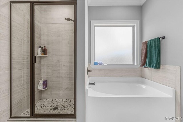 full bath featuring a garden tub and a shower stall