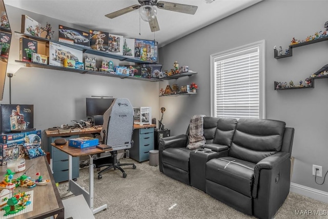 carpeted office with a ceiling fan