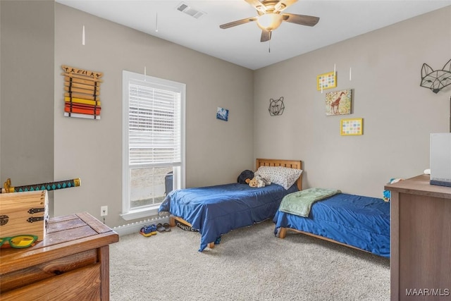 bedroom featuring a ceiling fan, carpet, and visible vents