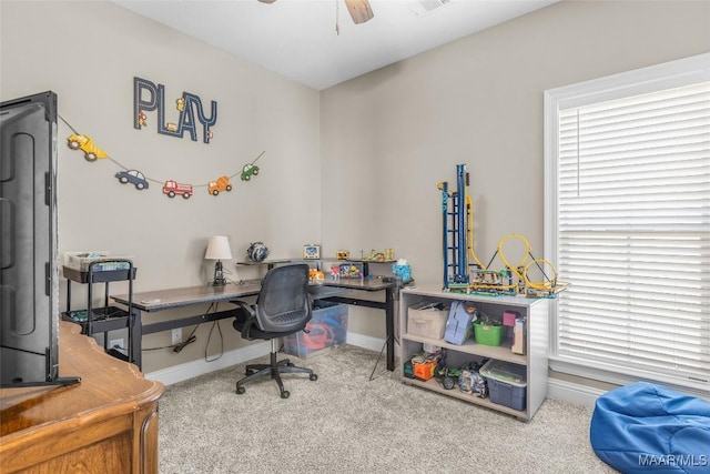 home office featuring carpet floors, ceiling fan, and baseboards