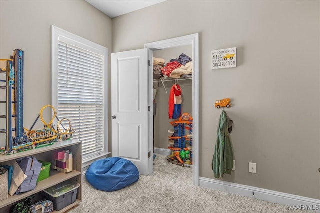 recreation room featuring carpet and baseboards