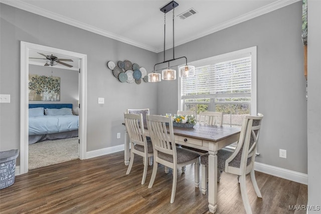 dining space with baseboards, visible vents, ceiling fan, dark wood-style flooring, and crown molding