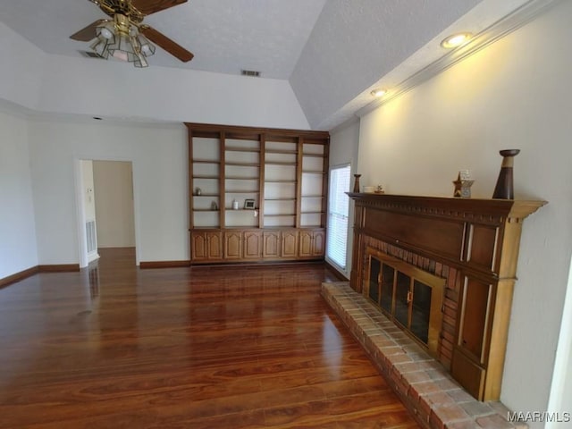 living room with dark wood-type flooring, ceiling fan, lofted ceiling, and a fireplace