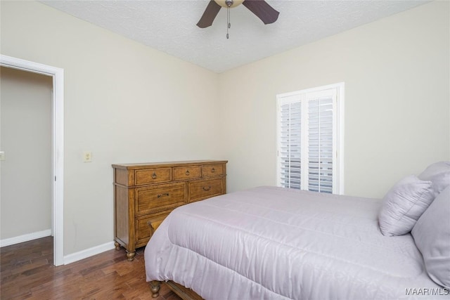 bedroom with ceiling fan, dark hardwood / wood-style floors, and a textured ceiling