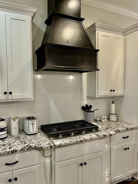 kitchen with crown molding, stainless steel gas cooktop, custom exhaust hood, and white cabinets