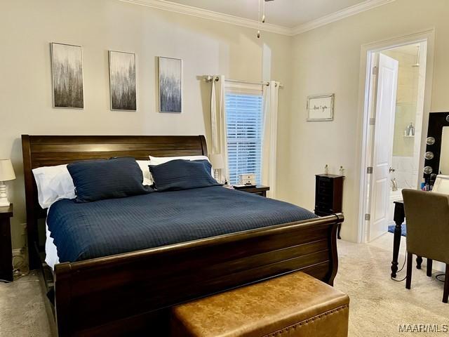 bedroom with crown molding and light colored carpet