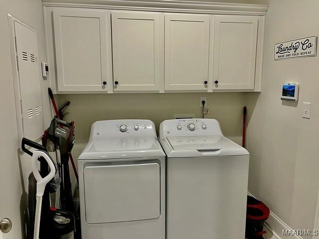 washroom with cabinets and independent washer and dryer