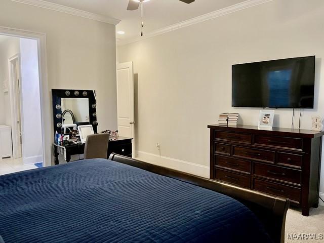 bedroom featuring crown molding, light colored carpet, and ceiling fan