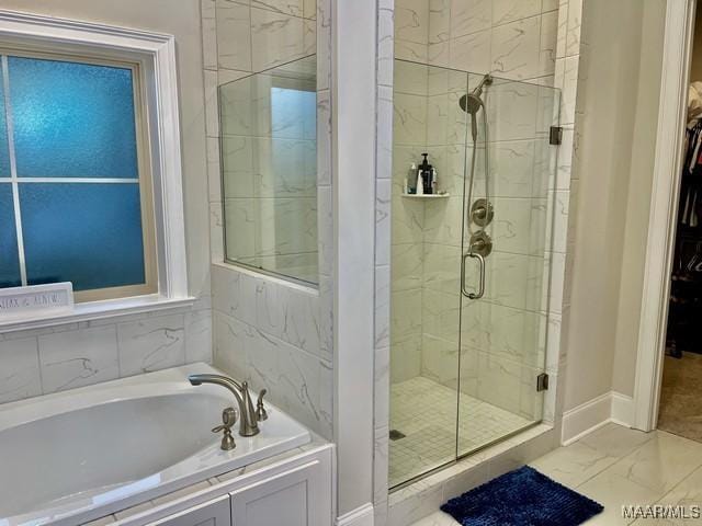 bathroom featuring separate shower and tub