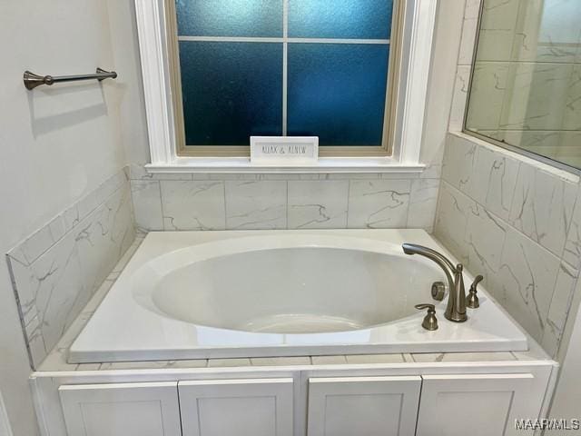 bathroom featuring a relaxing tiled tub