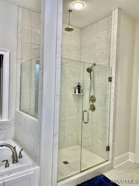 bathroom with separate shower and tub